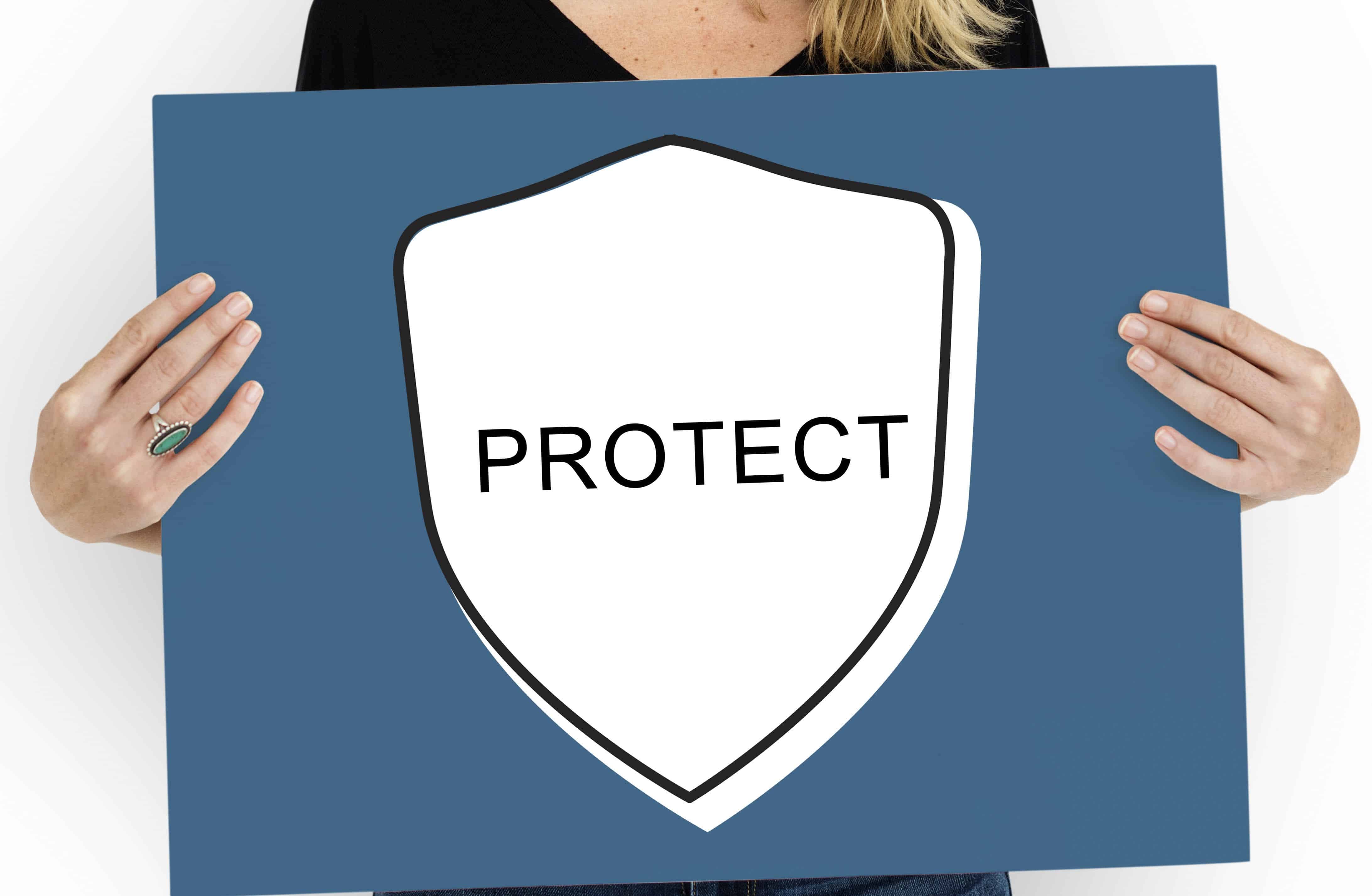Woman holding sign that says "Protect"